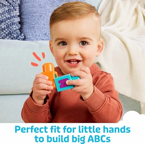 Baby playing with colorful letter blocks.