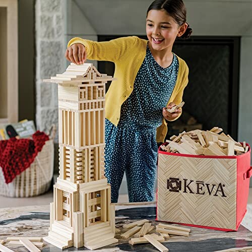 Child building a wooden tower with KEVA planks.