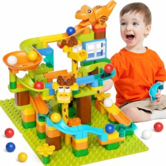 Child playing with colorful marble run toy set.