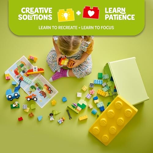 Child playing with colorful toy bricks and blocks on a green background.