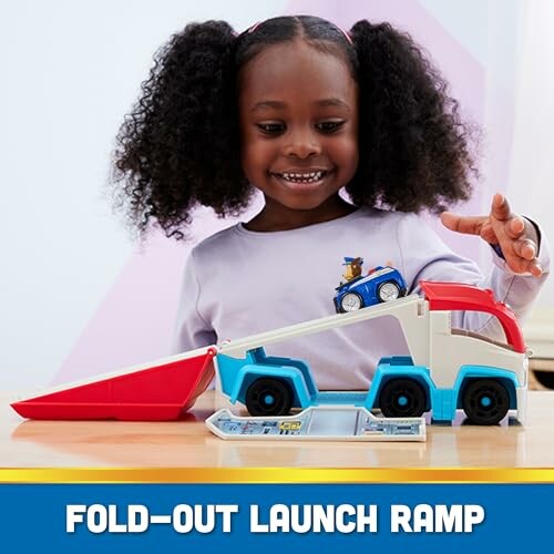 Child playing with a toy car and fold-out launch ramp.