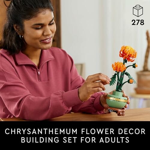 Woman assembling chrysanthemum flower decor building set