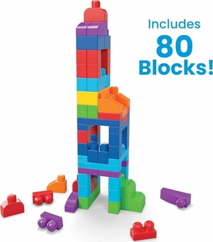 Tall tower made of colorful building blocks with scattered pieces.