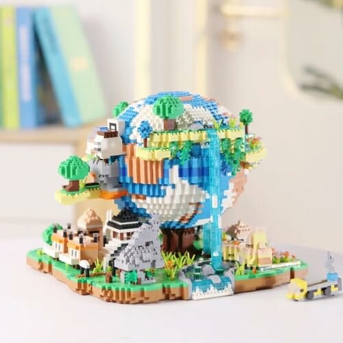 Colorful LEGO globe diorama with landscapes and buildings.