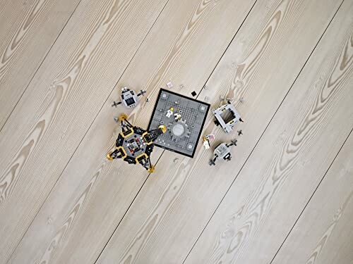 LEGO spacecraft models on wooden floor.