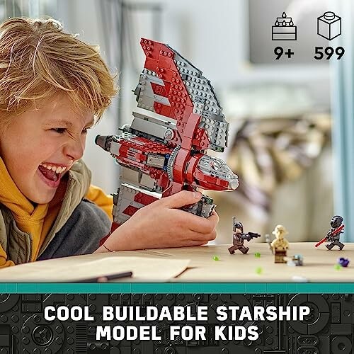 Child excitedly holding a buildable Lego starship model with minifigures.