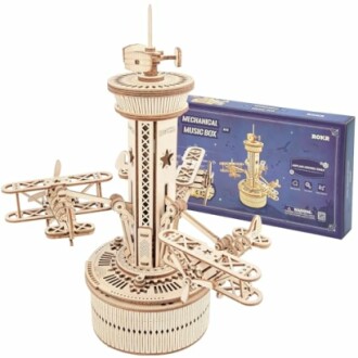 Wooden mechanical music box kit with airplane design and packaging.