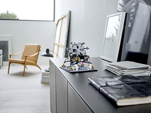 Modern room with a LEGO lunar lander model on a cabinet.