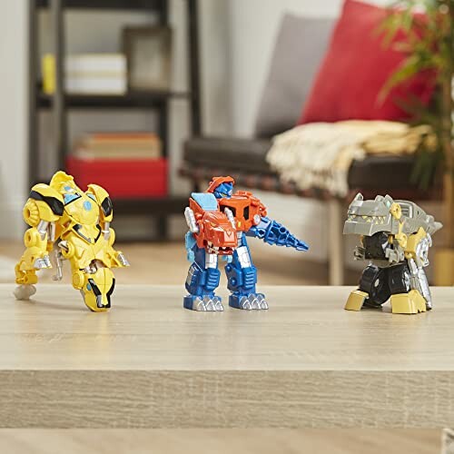 Three colorful robot dinosaur toys on a table.