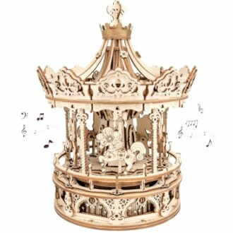 Intricate wooden carousel music box with horse figures.