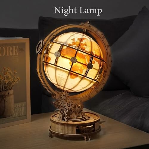 Wooden globe night lamp with warm light on a table.