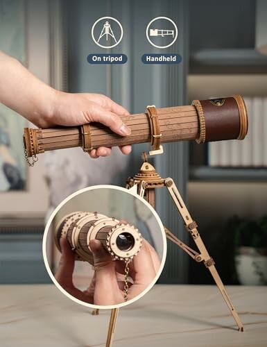 Hand holding a wooden telescope with options for tripod or handheld use.